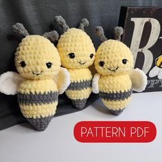 three crocheted bees sitting next to each other