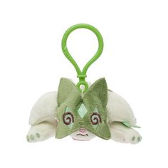 a small stuffed animal keychain with a green cat on it's face