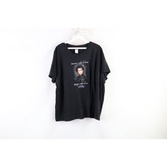 a black t - shirt hanging on a white wall with an image of michael jackson