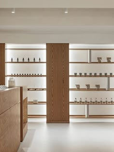 an empty store with wooden shelves filled with items