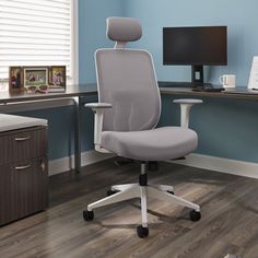 an office chair sitting in front of a computer desk