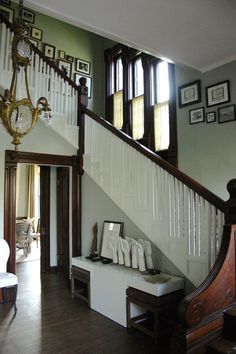 the stairs in this house have been decorated with white and brown accents, along with pictures on the wall