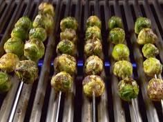 the brussel sprouts are being cooked on the grill