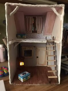 a doll house made out of cardboard and wood