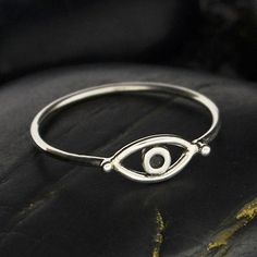 This sterling silver evil eye ring is perfect for stacking. While evil eye amulets were first recorded by the Mesopotamians about 5,000 years ago on clay tablets, belief in their protective power is still strong in many parts of the world. People attach an evil eye amulet to everything they wish to protect from envy an Evil Eye Ring Silver, Evil Eye Amulet, Travel Charms, Seeing Eye, Pendant Bails, All Seeing Eye, Evil Eye Ring, Silver Bead Bracelet, Mini Charm