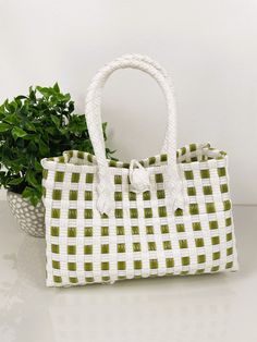 "SAGE GREEN TOTE HANDBAG  9.5\"x4.5\" WIDE Very durable and fashionable hand-woven market-style checkered handbag. We have many different colors available. This bag is made of premium plastic and embellished with beautiful beaded handles.  Let us help you replicate that special beach island getaway feels with imported Balinese products at wholesale prices. We are your source for crisp and clean bohemian coastal decor to echo that pure and organic lifestyle you've been looking for. We'll provide Trendy Green Tote Satchel, Trendy Green Satchel For Shopping, Trendy Green Tote Shoulder Bag, Trendy Green Rectangular Shoulder Bag, Green Square Bag With Large Capacity, Green Square Bags With Large Capacity, Trendy Green Satchel With Removable Pouch, Casual Green Tote Shoulder Bag, Casual Green Bucket Shoulder Bag