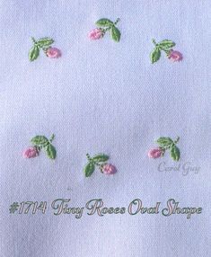 embroidered flowers and leaves on white fabric with words that read, the tiny roses oval shape