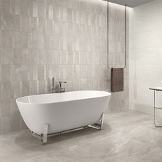 a white bath tub sitting on top of a bathroom floor