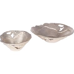 two silver bowls sitting next to each other