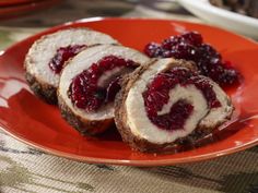 two pieces of meatloaf with cranberry sauce on an orange plate