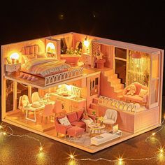 a doll house with furniture and lights on the inside is lit up at night time