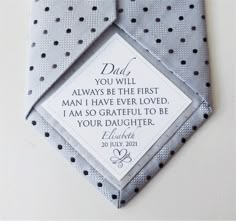 a polka dot tie with a father's day card attached to the necktie