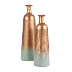 two gold vases sitting next to each other