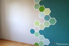 the wall is painted with hexagons in green and blue colors on it