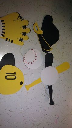 paper cutouts of baseballs and mitts on a table