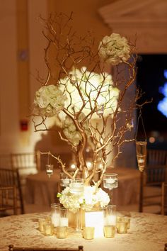 the centerpieces are decorated with flowers and candles for an elegant touch to the table