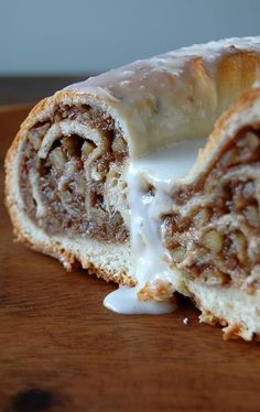 a cinnamon roll with icing and nuts on it