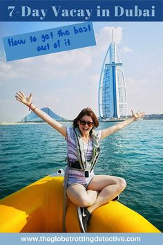 a woman sitting on top of a yellow boat in front of the burj