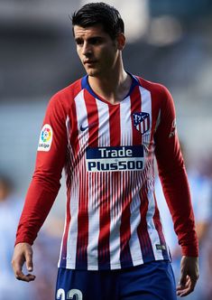 a close up of a soccer player wearing a red, white and blue uniform