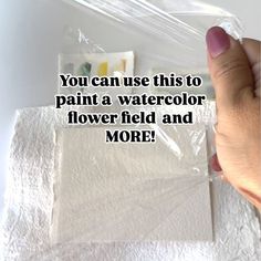 someone is holding up a piece of paper with the words you can use this to paint a watercolor flower field and more