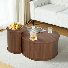 two coffee tables sitting on top of a white rug