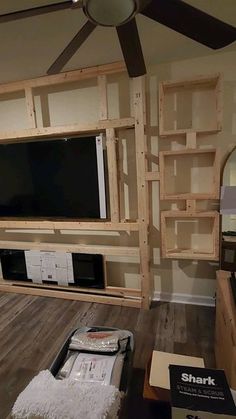 a living room with shelves and a flat screen tv