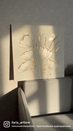 a white card with gold foil flowers on it