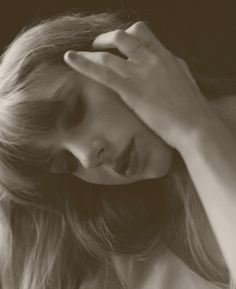 a black and white photo of a woman with her hands on her head