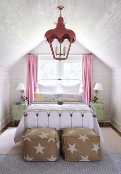 an instagramted photo of a bedroom with pink curtains and white bedding in the attic