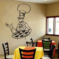 a wall decal with a chef holding a pizza on it's side in a restaurant