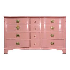 a pink dresser with gold knobs on the top and bottom drawers, against a white background