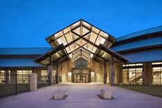 the front entrance to a large building lit up at night