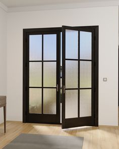 an open door with frosted glass on the inside and outside, in front of a white wall