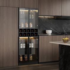 a modern kitchen with marble counter tops and wooden cabinets, along with an island in the middle