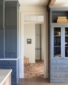 a kitchen with blue cabinets and white walls