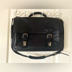 This Buttery Soft Black Coach Messenger Bag Is In Near Perfect Condition. The Only Bit Of Wear Is On A Couple Of The Bottom Corners. On The Inside Center, There Is One Large Padded Zippered Compartment For A Computer That Is 2 1/2 Inches Wide. In Front Of That, Behind The Buckle And Snap Enclosures, There Is An Open Compartment With Three Slip Pockets And Three Pen Pockets. On The Back Side Of The Bag, There Is One Large Open Pocket That Contains Three Slip Pockets And One Zippered Compartment. Measures: Length - 17” Width - 11” Depth 5” Stored In A Smoke-Free Home. Designer Office Satchel Bags, Designer Business Bags With Adjustable Strap, Designer Bags With Adjustable Strap For Business, Designer Black Bags For Office, Designer Black Office Bags, Designer Business Satchel With Double Handle, Designer Black Bag With Detachable Strap, Designer Double Handle Satchel For Business, Travel Briefcase With Silver-tone Hardware And Top Handle