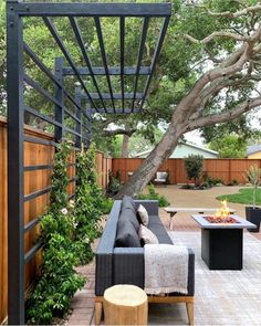 an outdoor patio with seating and fire pit