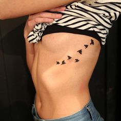 a woman with birds on her stomach and the bottom part of her body is shown