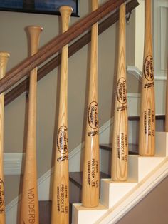 the wooden bats are lined up on the stair case in front of the door way