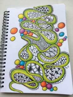 a spiral notebook with an abstract design on it