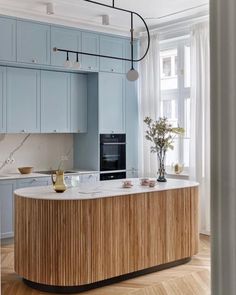 a kitchen with blue cabinets and white counter tops