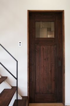 a wooden door sitting next to a set of stairs