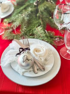 a christmas table setting with silverware and ornaments