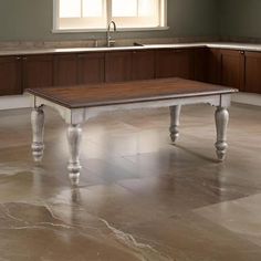 a kitchen with marble flooring and wooden cabinets in the corner, along with a white coffee table