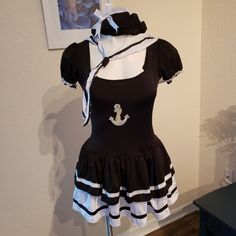 a black and white dress with an anchor on the chest, tied to a stand