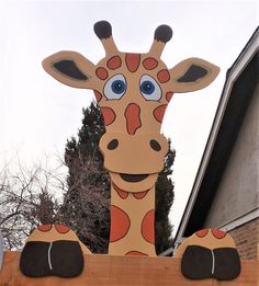 a large wooden giraffe with big blue eyes