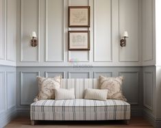 a couch sitting in the middle of a living room next to two lamps on either side of it