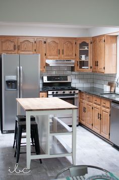 a kitchen with stainless steel appliances and wooden cabinets