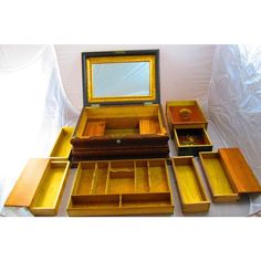 an assortment of wooden boxes and drawers with a mirror in the top one is empty