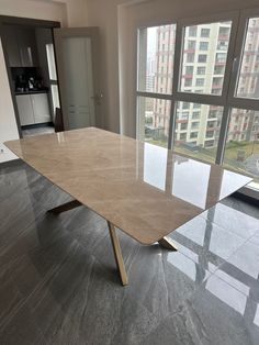 an empty table in front of a large window